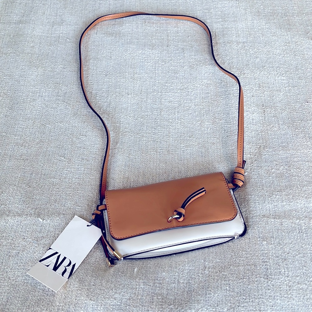 Zara small cross body purse 8.5”L x2” Wx 4.25”H, 2 tone cream and camel.